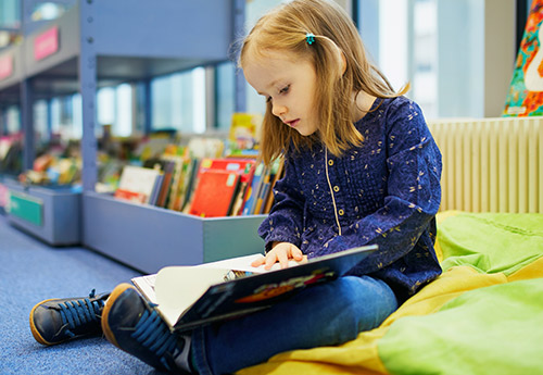 Little girl reading a book